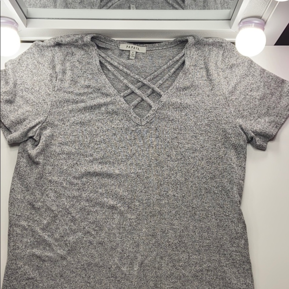 Knitted grey shirt, opening with cross pattern